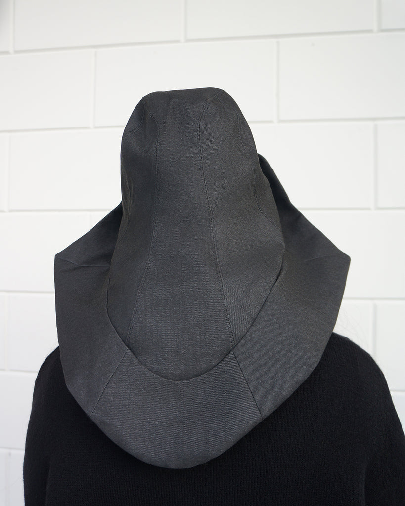 back view Person wearing a denim, waterproof rain hat