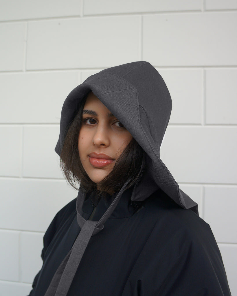 side/front view Person wearing a denim, waterproof rain hat