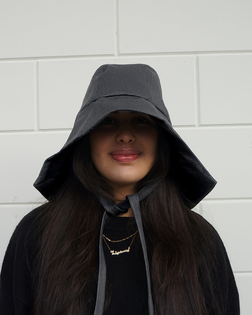 Person wearing a denim rain hat