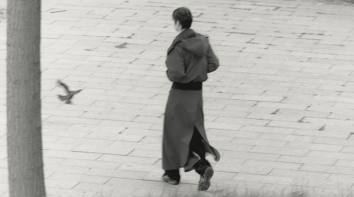 woman walking in Nova bomber rain jacket and moxie rain skirt