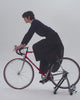 man on a race bike wearing rainproof skirt that transforma into rain trousers/pants