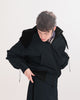 Person wearing a black, waterproof, bomber jacket with elasticated waist and cuffs, on a white background