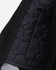 A close up of the sustainable, zipped, black, detachable liner for raincoat made from 100% recycled polyester