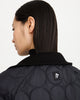 Close up of sustainable, zipped, black, detachable liner for raincoat made from 100% recycled polyester with BYBROWN logo