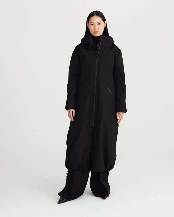 Long black, waterproof, breathable, technical and sustainable winter warm raincoat with recycled, detachable liner.